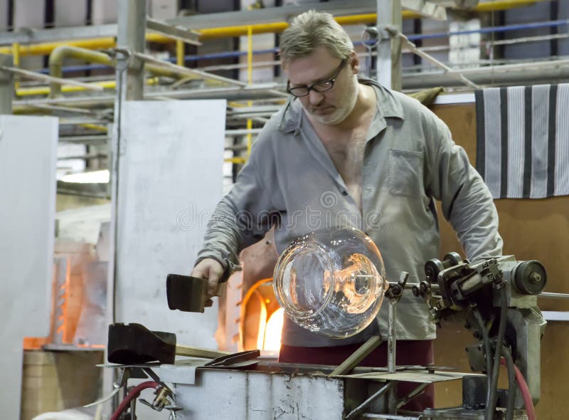 KARLOVY VARY, CZECH REPUBLIC - SEPTEMBER 14, 2014:Glass blowers demonstrate their craft, a popular tourist attraction, September 14, 2014 in Karlovy Vary, Czech Republic. KARLOVY VARY, CZECH REPUBLIC - SEPTEMBER 14, 2014:Glass blowers demonstrate their craft, a popular tourist attraction, September 14, 2014 in Karlovy Vary, Czech Republic.