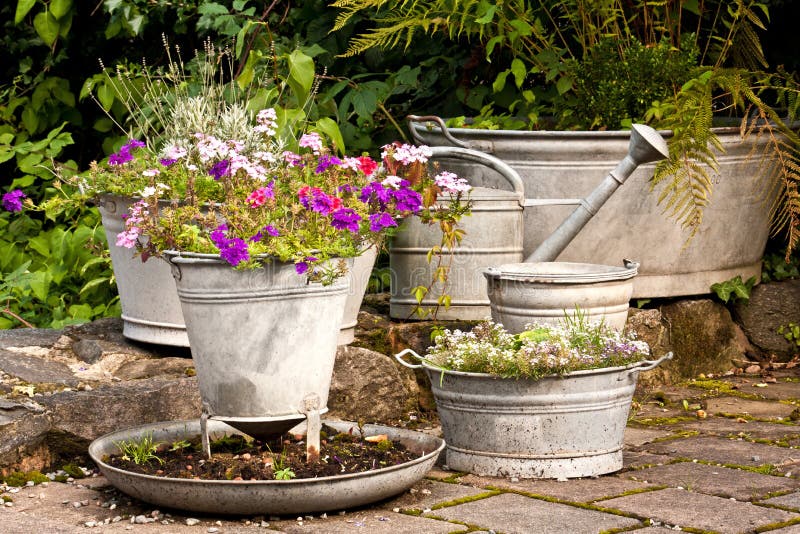 Idyllic garden with flowers in zinc containers. Idyllic garden with flowers in zinc containers