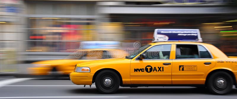 A panning shot of a yellow cab in manhattan. A panning shot of a yellow cab in manhattan