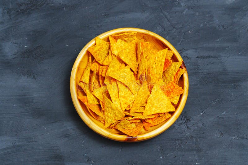 Bowl is filled with crispy tortilla chips, creating a savory snack ready to be enjoyed. Bowl is filled with crispy tortilla chips, creating a savory snack ready to be enjoyed.