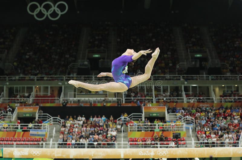 Καλλιτεχνικός gymnast Aliya Mustafina της Ρωσικής Ομοσπονδίας ανταγωνίζεται στην ακτίνα ισορροπίας στην ολόγυρη γυμναστική γυναικ στοκ φωτογραφία με δικαίωμα ελεύθερης χρήσης Καλλιτεχνικός gymnast Aliya Mustafina της Ρωσικής Ομοσπονδίας ανταγωνίζεται στην ακτίνα ισορροπίας στην ολόγυρη γυμναστική γυναικ στοκ φωτογραφία με δικαίωμα ελεύθερης χρήσης