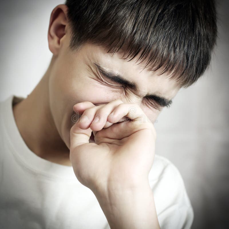 Vignetting Photo of Sorrowful Teenager on the gray background. Vignetting Photo of Sorrowful Teenager on the gray background