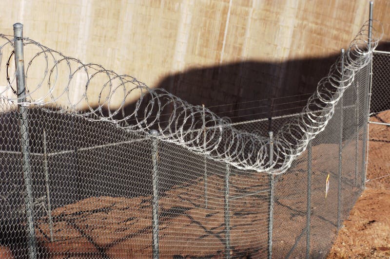 Chain link fence with razor wire. Chain link fence with razor wire.