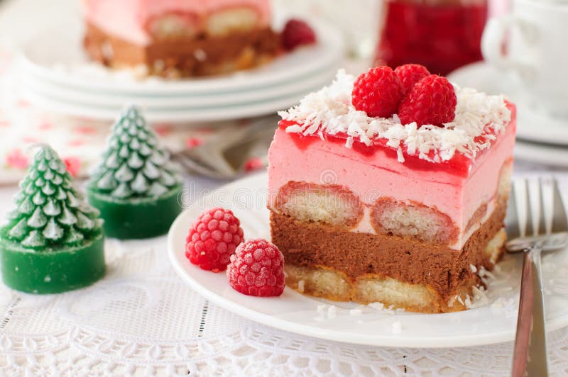 A Piece of No Bake Layer Cake (Savoiardi Soaked in Raspberry Liqueur, Chocolate Mousse, Raspberry Mousse and Raspberry Jelly), Christmas Atmosphere. A Piece of No Bake Layer Cake (Savoiardi Soaked in Raspberry Liqueur, Chocolate Mousse, Raspberry Mousse and Raspberry Jelly), Christmas Atmosphere