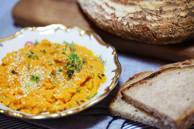 Carrot, pumpkin and sweet potato spread or dip with sliced bread and thyme. Carrot, pumpkin and sweet potato spread or dip with sliced bread and thyme