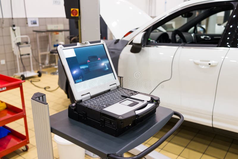 Car in a professional auto repair shop,testing with laptop. Car in a professional auto repair shop,testing with laptop