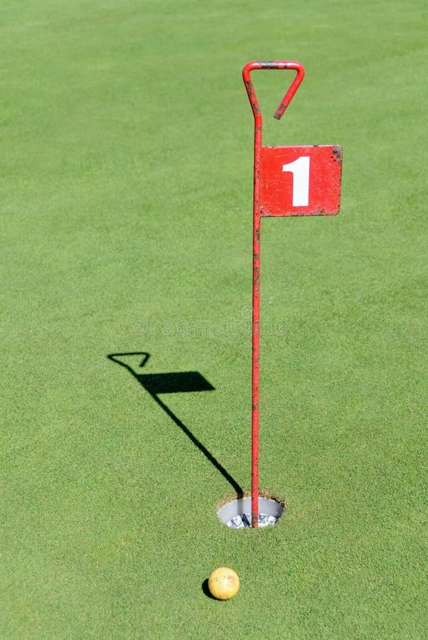 A vertical shot of number 1  sign in a golf hole. A vertical shot of number 1  sign in a golf hole