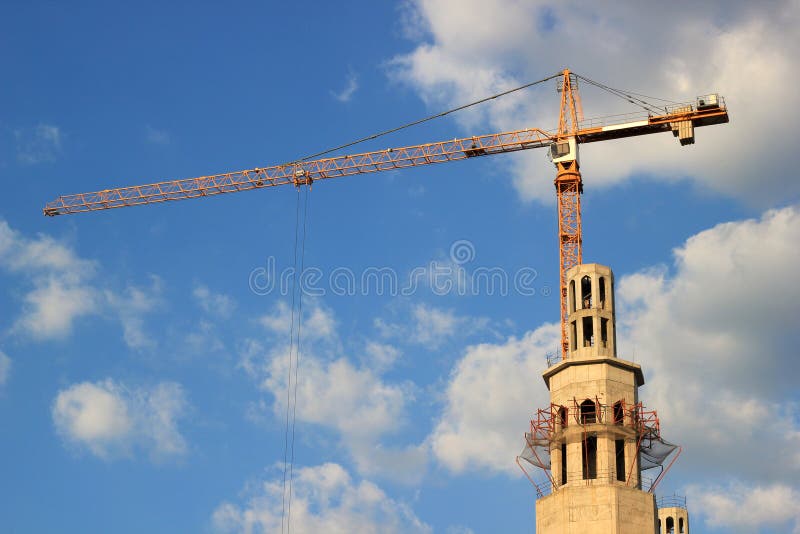 Construction of mosque with crane on a clear summer day. Construction of mosque with crane on a clear summer day