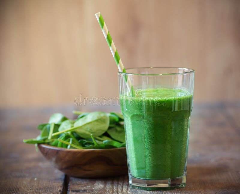 Spinach smoothie on wooden table. Spinach smoothie on wooden table