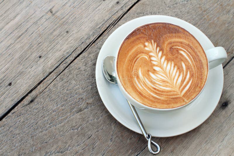 Hot milke coffee on wood table. Hot milke coffee on wood table