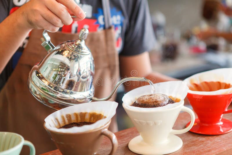 Καφές σταλαγματιάς χεριών, χύνοντας νερό Barista στο έδαφος καφέ με το FI στοκ φωτογραφίες με δικαίωμα ελεύθερης χρήσης Καφές σταλαγματιάς χεριών, χύνοντας νερό Barista στο έδαφος καφέ με το FI στοκ φωτογραφίες με δικαίωμα ελεύθερης χρήσης