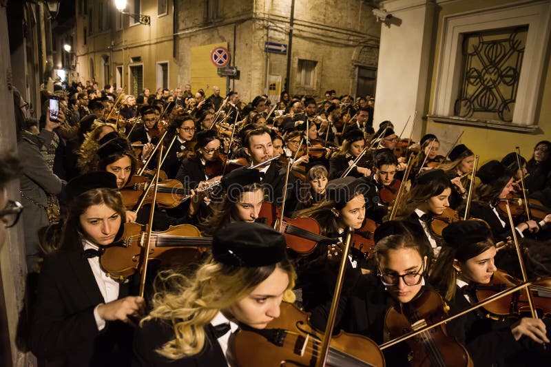 Chieti, Italy - 29 March 2024: Cellists during the famous Good Friday procession in Chieti (Italy. Chieti, Italy - 29 March 2024: Cellists during the famous Good Friday procession in Chieti (Italy