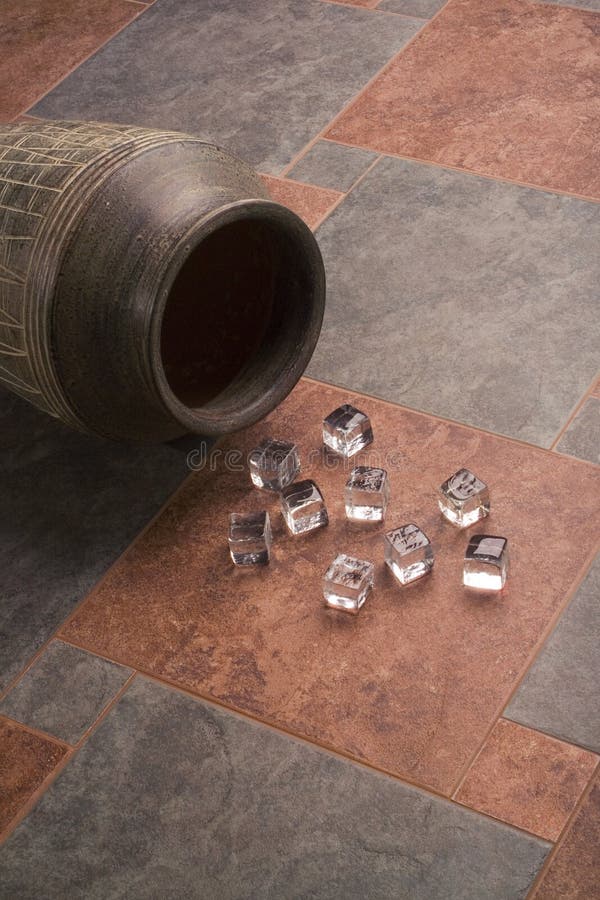 Ice cubes over ceramic tiles and a ceramic vase. Ice cubes over ceramic tiles and a ceramic vase