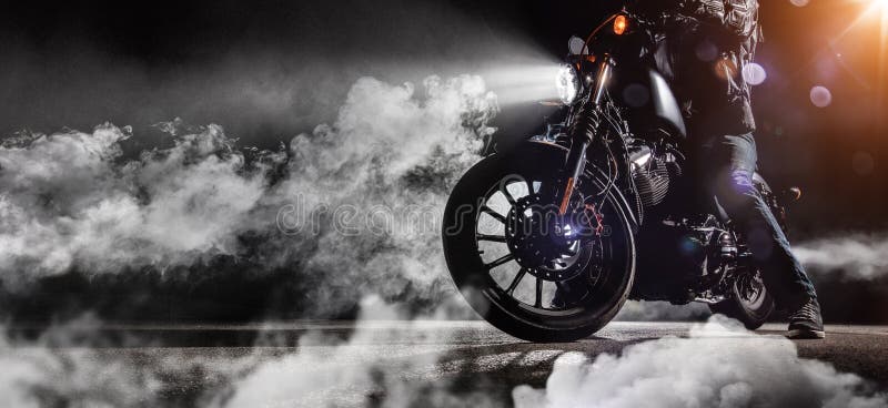 Close-up of high power motorcycle chopper with man rider at night. Fog with backlights on background. Close-up of high power motorcycle chopper with man rider at night. Fog with backlights on background.