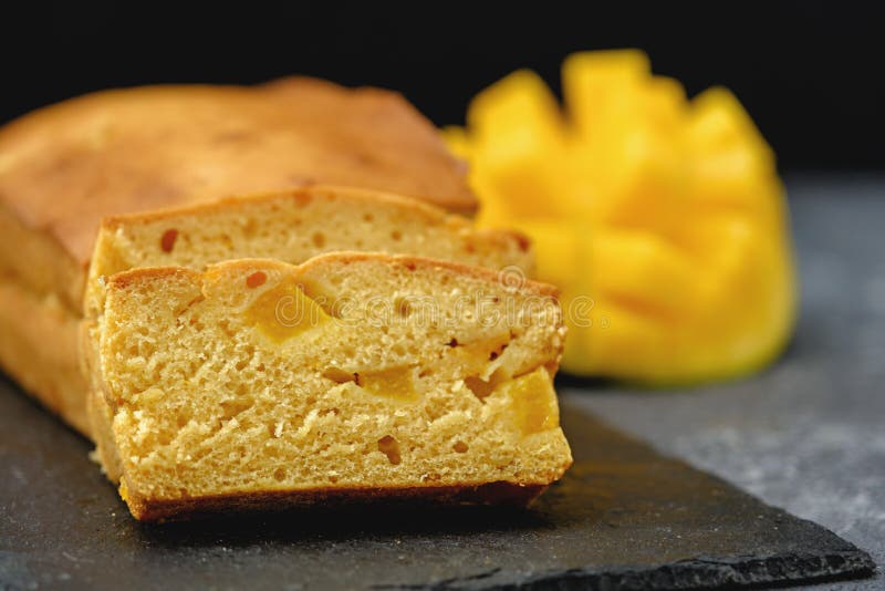 Closeup mango cake on black backround, homemade pound cake concept. Closeup mango cake on black backround, homemade pound cake concept