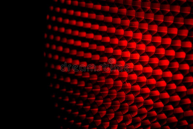 Closeup honeycomb grid texture with red light. Red and dark metal hexagon shaped pattern abstract background. Light modifier equipment. Metal honeycomb. Futuristic pattern. Honey grid cells network. Closeup honeycomb grid texture with red light. Red and dark metal hexagon shaped pattern abstract background. Light modifier equipment. Metal honeycomb. Futuristic pattern. Honey grid cells network