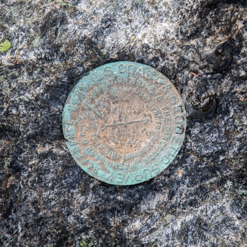 A closeup of summit geological survey marker on the top of Mount Marcy, Adirondacks Upstate New York. A closeup of summit geological survey marker on the top of Mount Marcy, Adirondacks Upstate New York