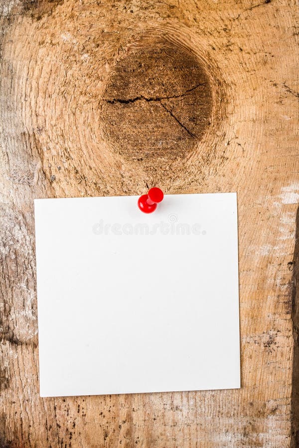 White paper sticky note reminder With red Push Pin on wooden old background. White paper sticky note reminder With red Push Pin on wooden old background