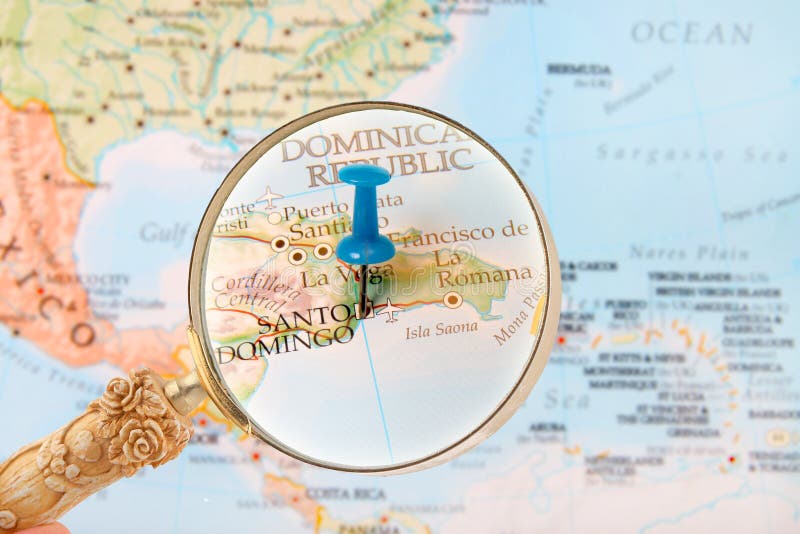 Blue tack on map of the Caribbean with magnifying glass looking in on Santo Domingo, Dominican Republic. Blue tack on map of the Caribbean with magnifying glass looking in on Santo Domingo, Dominican Republic