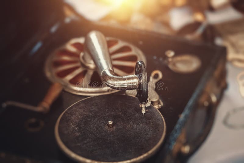 Closeup vintage record player from 50`s or 60`s on the countertop in sunday flea market. Details from antique bazaar. Closeup vintage record player from 50`s or 60`s on the countertop in sunday flea market. Details from antique bazaar