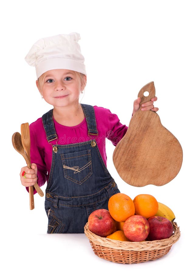 Close-up portrait of a little girl holding fruits and kitchen appliances. Close-up portrait of a little girl holding fruits and kitchen appliances