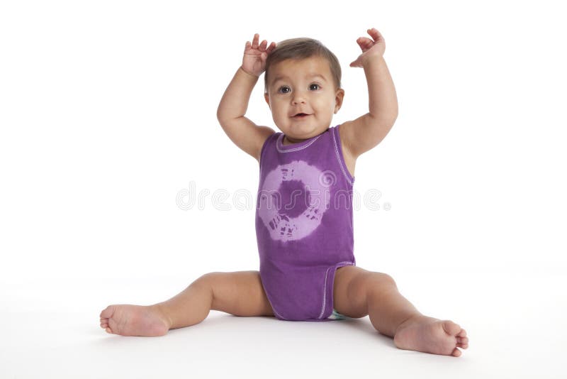 Baby girl sitting in ballet position no.3 on white background. Baby girl sitting in ballet position no.3 on white background