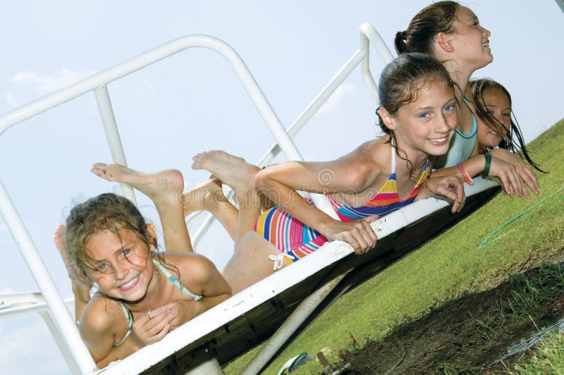 Young girls playing on carousel. Young girls playing on carousel