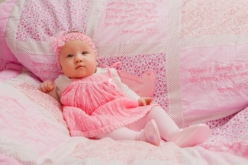 Baby girl on pink blanket with Bible verses. Baby girl on pink blanket with Bible verses