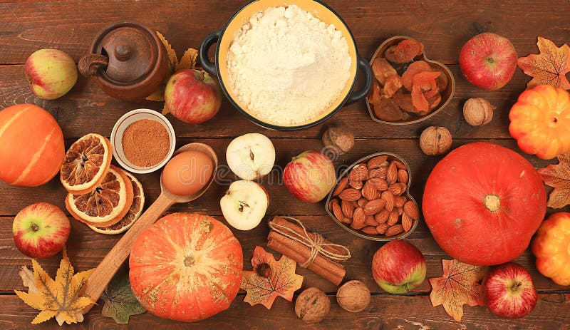 Kitchen background with pumpkin, apples, spices, nuts, flour, eggs, food preparation concept, ingredients for pumpkin and apple pies recipe, menu for restaurant, selective focus, top view, space for text. Kitchen background with pumpkin, apples, spices, nuts, flour, eggs, food preparation concept, ingredients for pumpkin and apple pies recipe, menu for restaurant, selective focus, top view, space for text