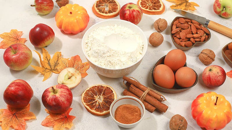 Kitchen background with pumpkin, apples, spices, nuts, flour, eggs, food preparation concept, ingredients for pumpkin and apple pies recipe, menu for restaurant, selective focus, top view, space for text. Kitchen background with pumpkin, apples, spices, nuts, flour, eggs, food preparation concept, ingredients for pumpkin and apple pies recipe, menu for restaurant, selective focus, top view, space for text