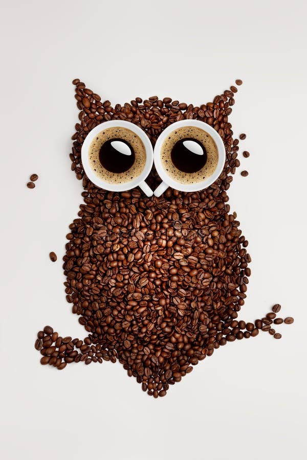 A funny owl made of roasted coffee beans and two cups. A funny owl made of roasted coffee beans and two cups.