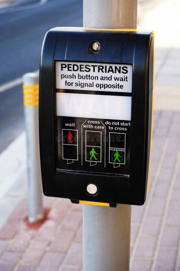 Pedestrians push button in the street. Pedestrians push button in the street