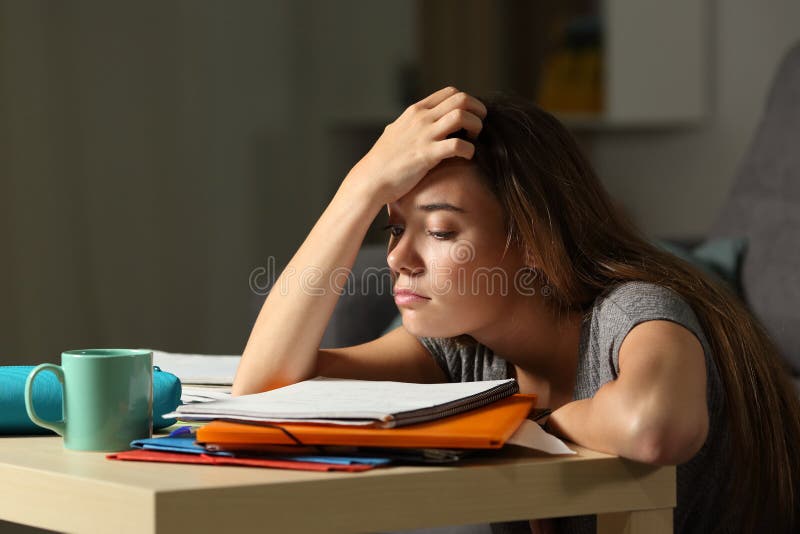 Tired student trying to study in the night at home. Tired student trying to study in the night at home