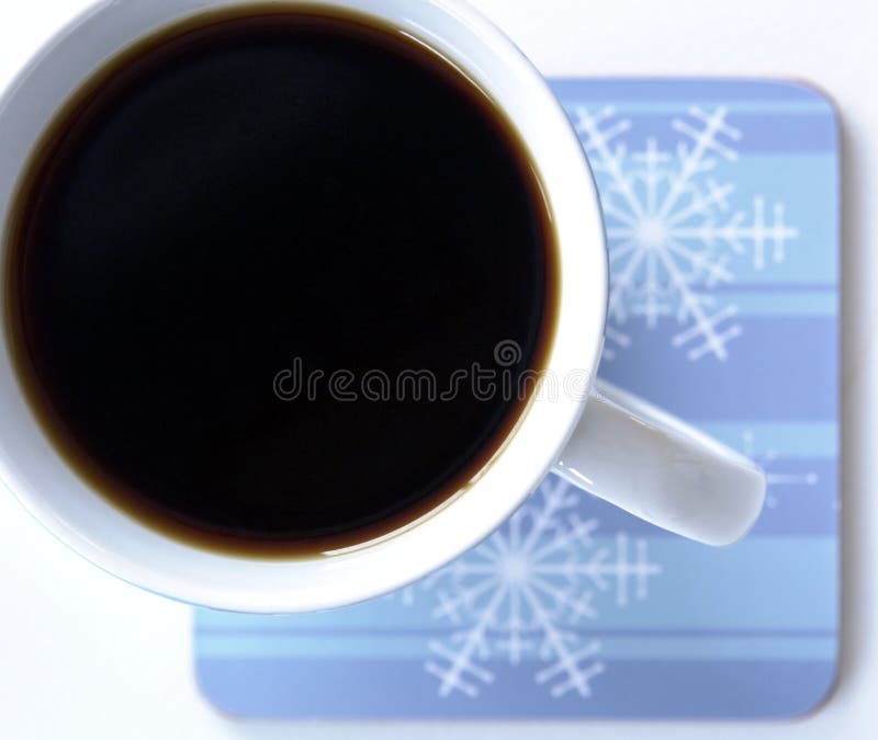 Cup of black coffee on a winter style coaster. Cup of black coffee on a winter style coaster