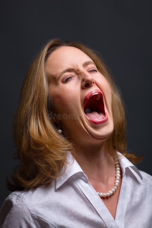 Portrait of woman with open mouth as if shouting, singing or screaming in pain. Portrait of woman with open mouth as if shouting, singing or screaming in pain