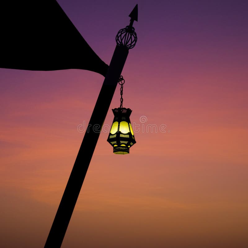 An illuminated Arabic hanging lantern against evening sky. An illuminated Arabic hanging lantern against evening sky
