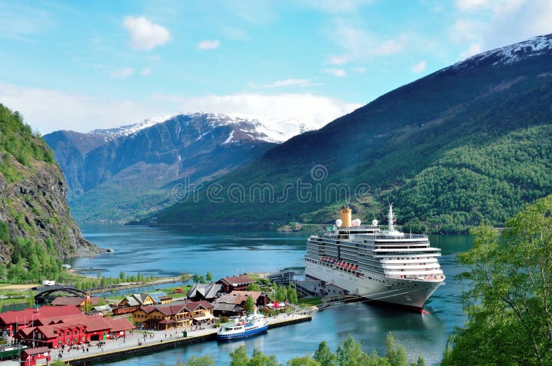 A Cruise ship docked in the village of FlÃ¥m in Norway. FlÃ¥m is a village at the inner end of the the fjord of Aurlandsfjorden, an arm of Sognefjorden. The cruise ship is the Arcadia of the P & O cruise line. A Cruise ship docked in the village of FlÃ¥m in Norway. FlÃ¥m is a village at the inner end of the the fjord of Aurlandsfjorden, an arm of Sognefjorden. The cruise ship is the Arcadia of the P & O cruise line.