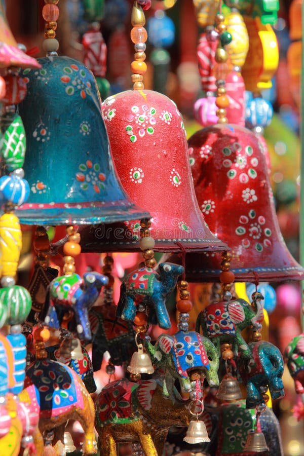 Colourful handmade wind chimes with decorated bells hanging in a local store in Rajasthan, India. Colourful handmade wind chimes with decorated bells hanging in a local store in Rajasthan, India.