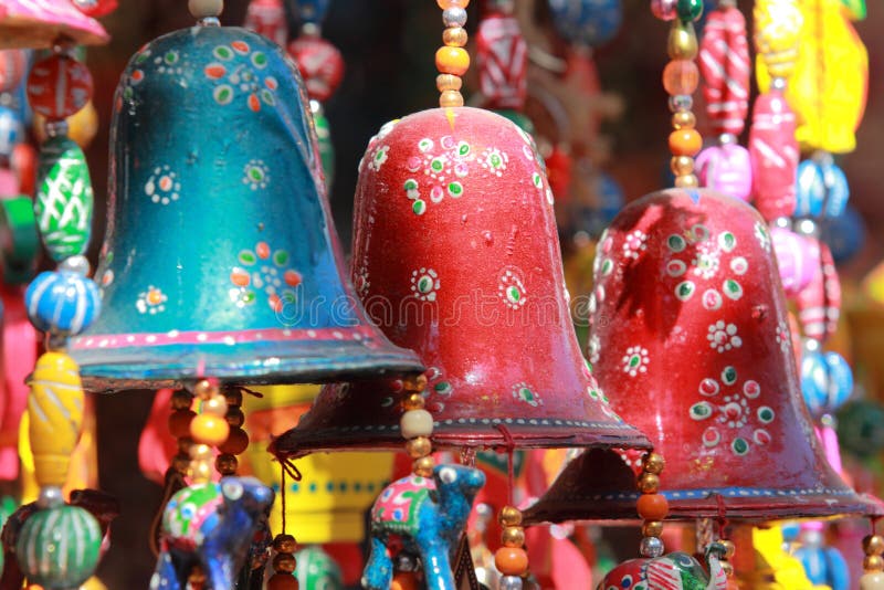 Colourful handmade wind chimes with decorated bells hanging in a local store in Rajasthan, India. Colourful handmade wind chimes with decorated bells hanging in a local store in Rajasthan, India.