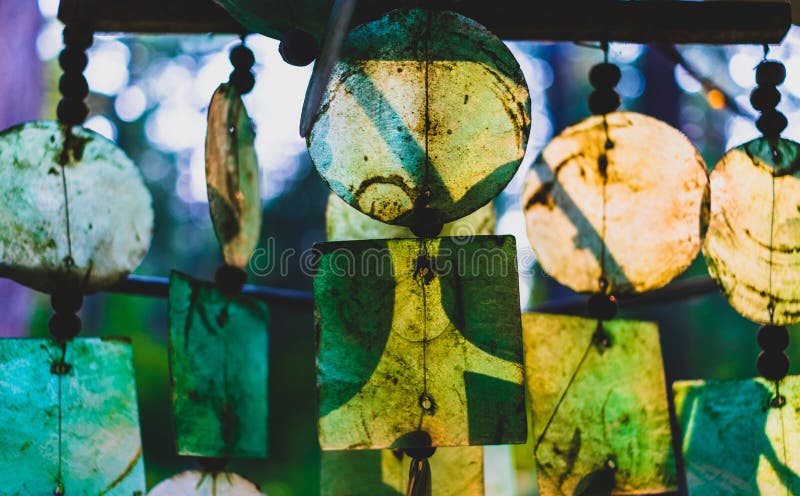 Glass wind chimes glowing in the evening light and hanging. Glass wind chimes glowing in the evening light and hanging