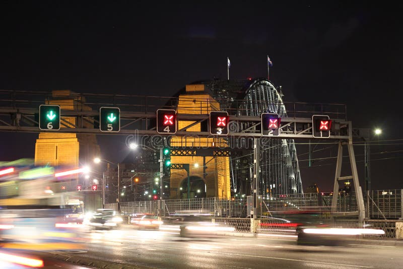 Blurred illustration of fast moving traffic to Sydney Harbour Bridge at night - view from North Sydney. Left-hand driving in Australia. Blurred illustration of fast moving traffic to Sydney Harbour Bridge at night - view from North Sydney. Left-hand driving in Australia.