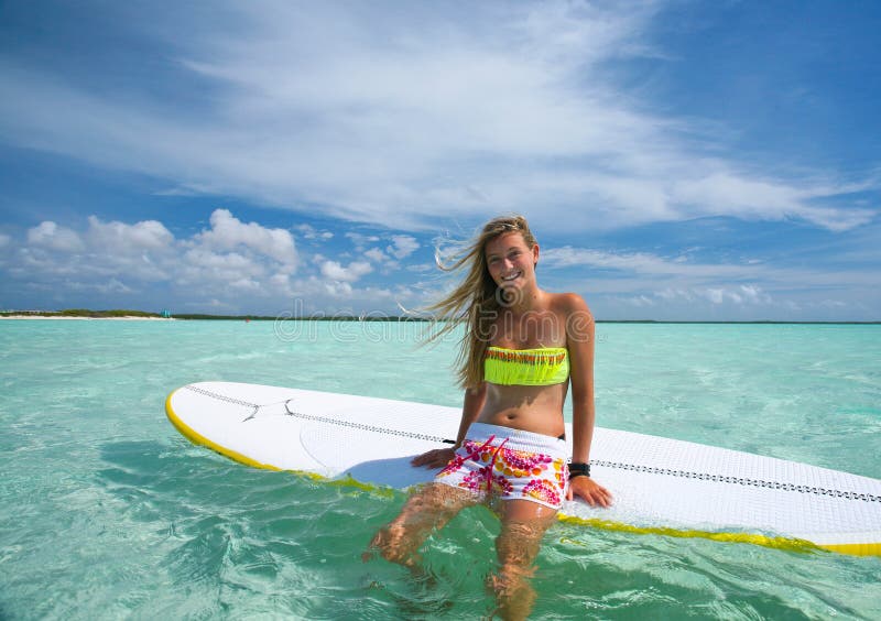 Beautiful surf girl on SUP (stand up paddle) board, Dutch Antilles, Caribbean islands. Beautiful surf girl on SUP (stand up paddle) board, Dutch Antilles, Caribbean islands.