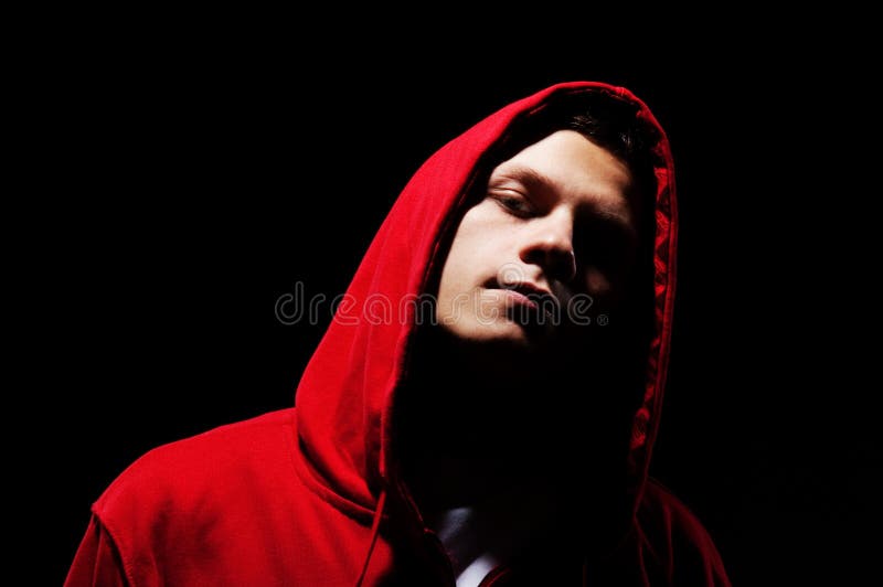 Hip-hop man in red hood against black background. Hip-hop man in red hood against black background