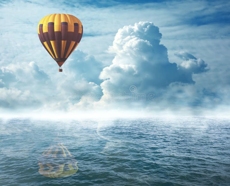 Dream world. Hot air balloon in cloudy sky over misty. Dream world. Hot air balloon in cloudy sky over misty