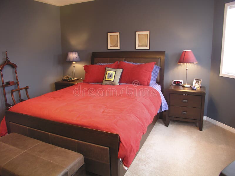 A modern master bedroom. Queen sized bed with red covers. A modern master bedroom. Queen sized bed with red covers.