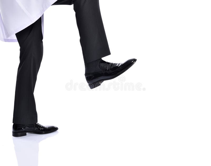 Young businessman kicking on white background studio. Young businessman kicking on white background studio.