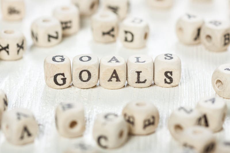 Word GOALS formed by wood alphabet blocks. On old wooden table. Word GOALS formed by wood alphabet blocks. On old wooden table.