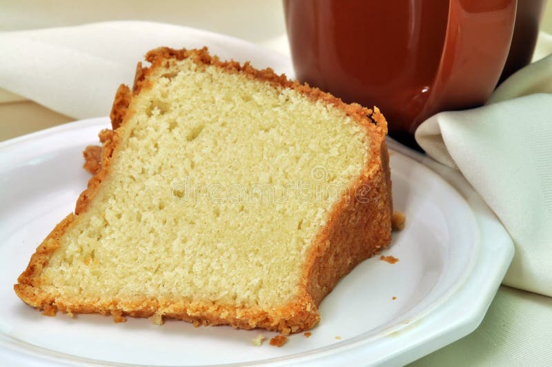 Closeup of pound cake with napkin and cup of coffee in background. Closeup of pound cake with napkin and cup of coffee in background.