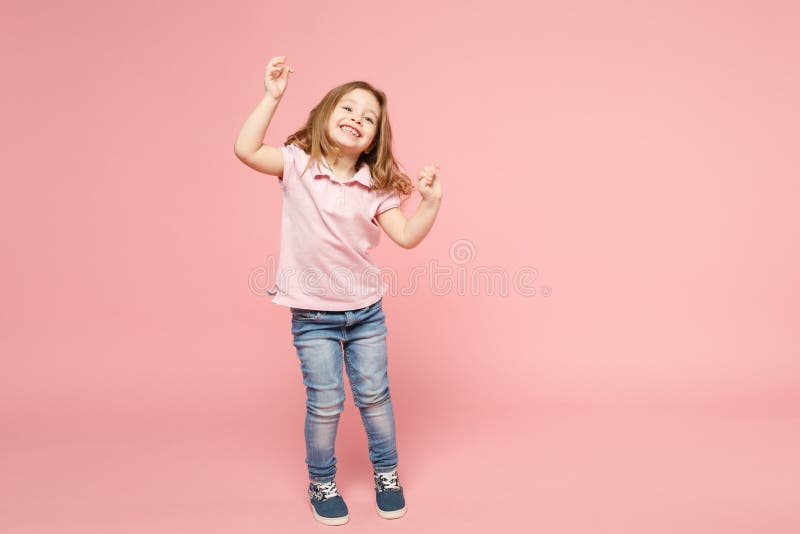 Little cute child kid baby girl 3-4 years old wearing light clothes dancing isolated on pastel pink wall background, children studio portrait. Mother`s Day, love family, parenthood childhood concept. Little cute child kid baby girl 3-4 years old wearing light clothes dancing isolated on pastel pink wall background, children studio portrait. Mother`s Day, love family, parenthood childhood concept