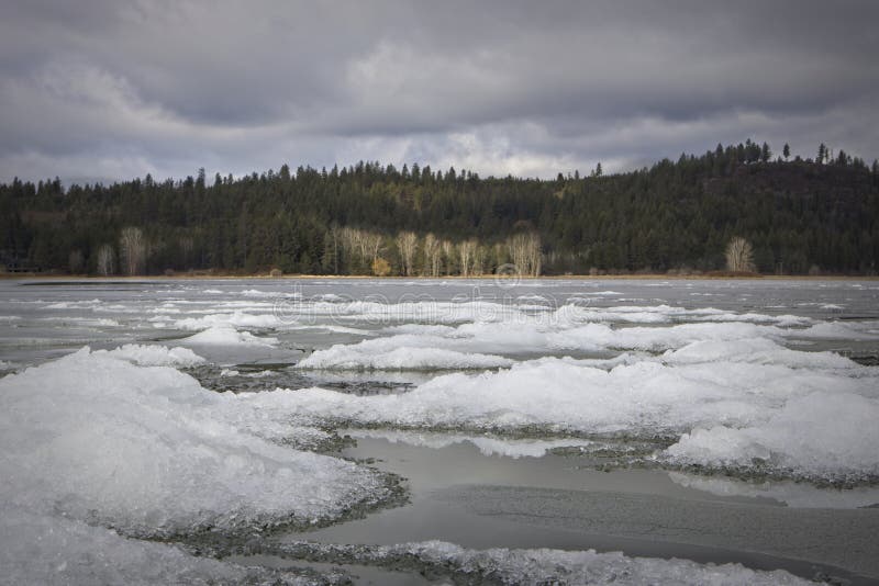 Snow is layered in clumps on a frozen yet slowly melting Hauser Lake in Idaho. Snow is layered in clumps on a frozen yet slowly melting Hauser Lake in Idaho